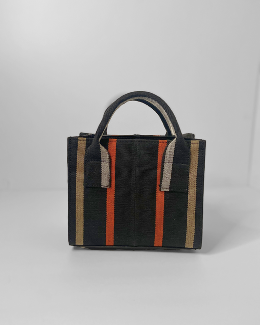 mini tote purse made out of black/orange/gold aso oke fabric and genuine leather.