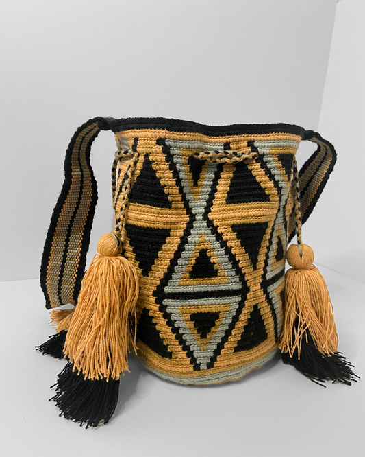 mini mochila bag with a bold triangular pattern and grey/brown/light orange neutral tones